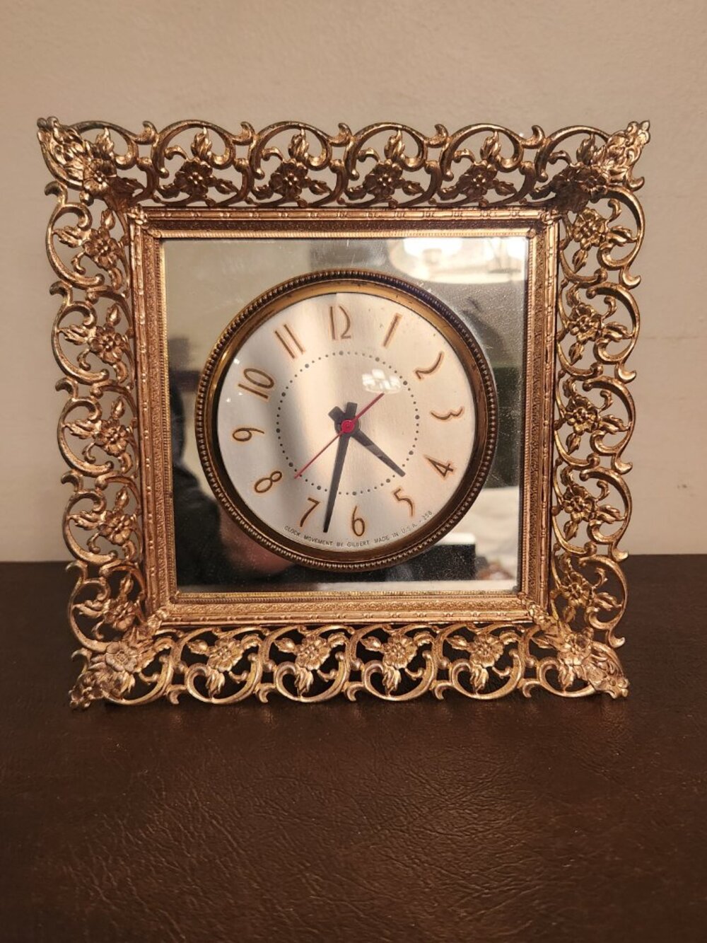 Vintage French-Style Ormolu Electric Table Clock features a gold tone floral fra
